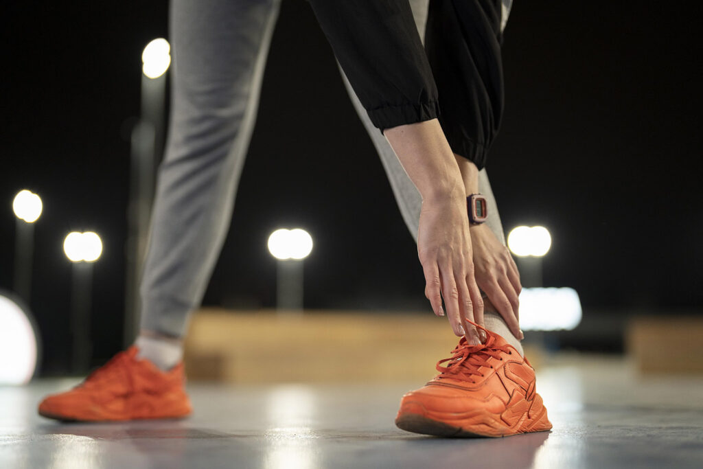 close up hands touching foot